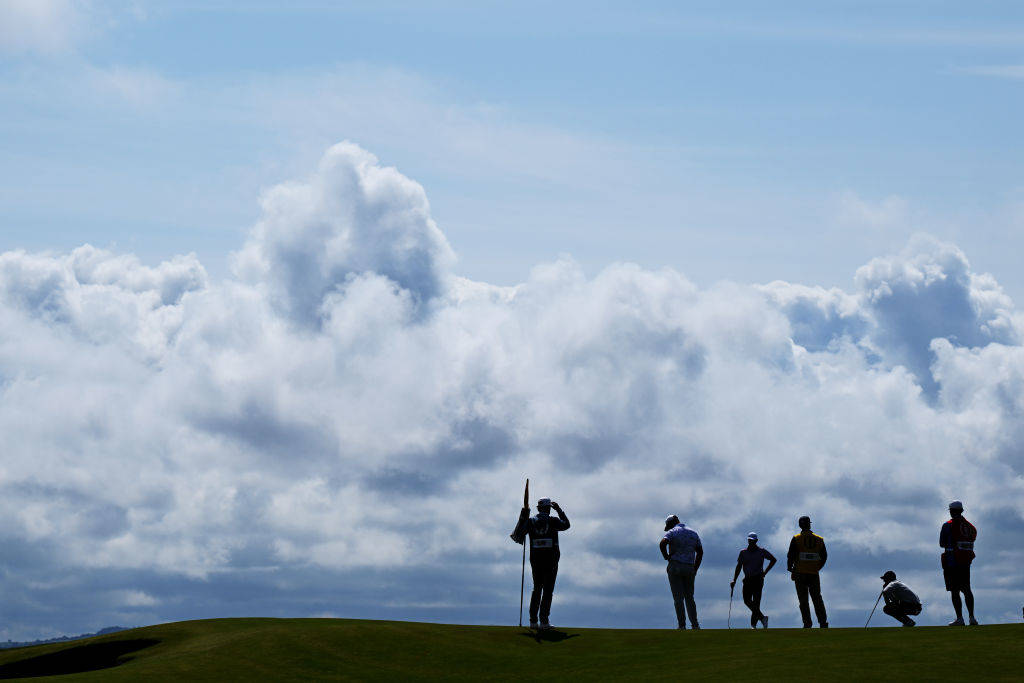 Rory McIlroy lines up a putt on the 17th green